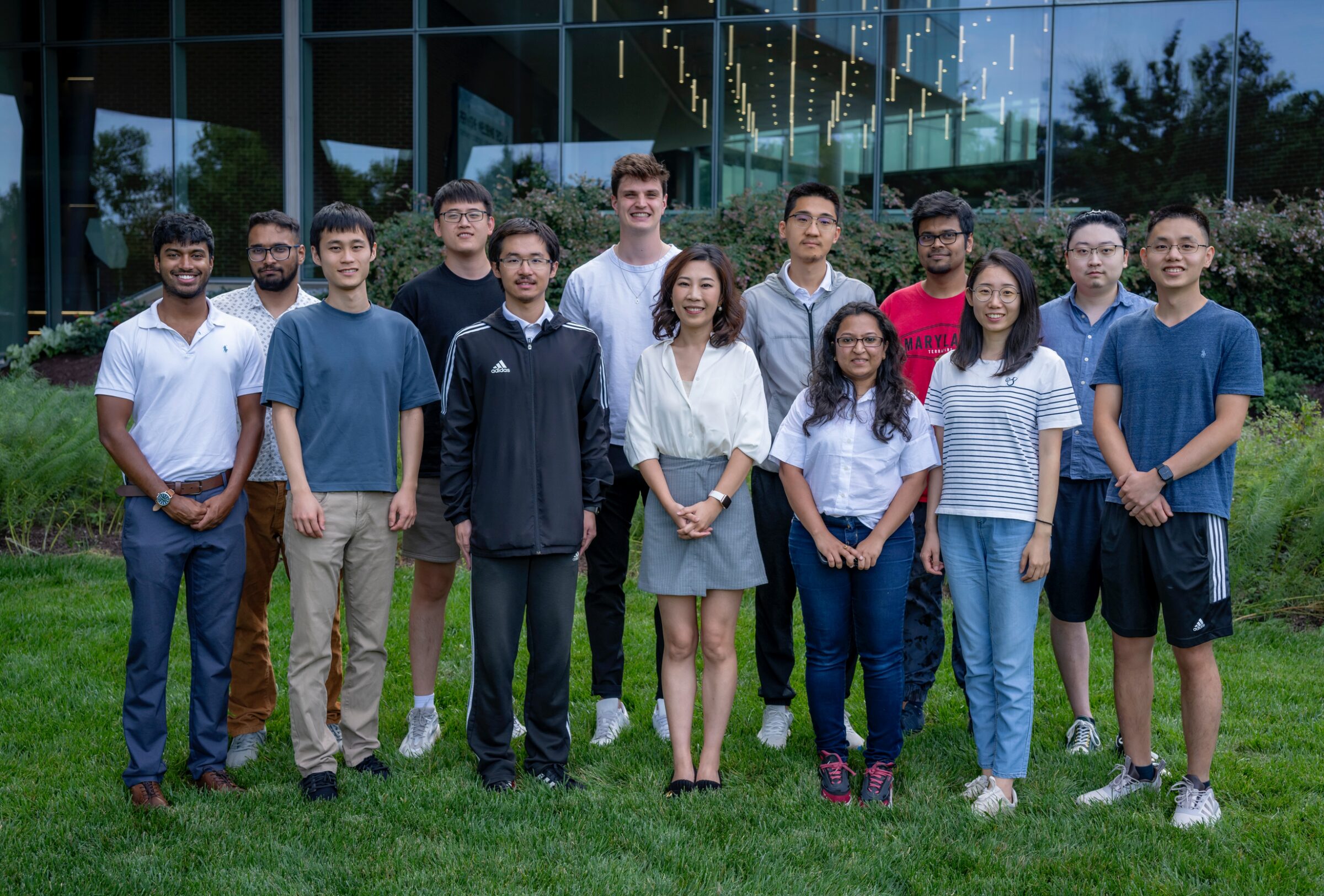 Furong Huang with members of Furong Lab outside a University of Maryland building