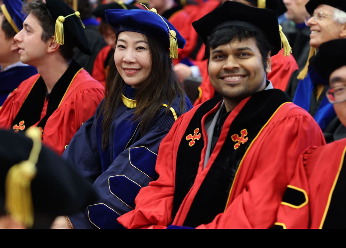 Furong Huang and a Furong Lab graduate seated at University of Maryland commencement