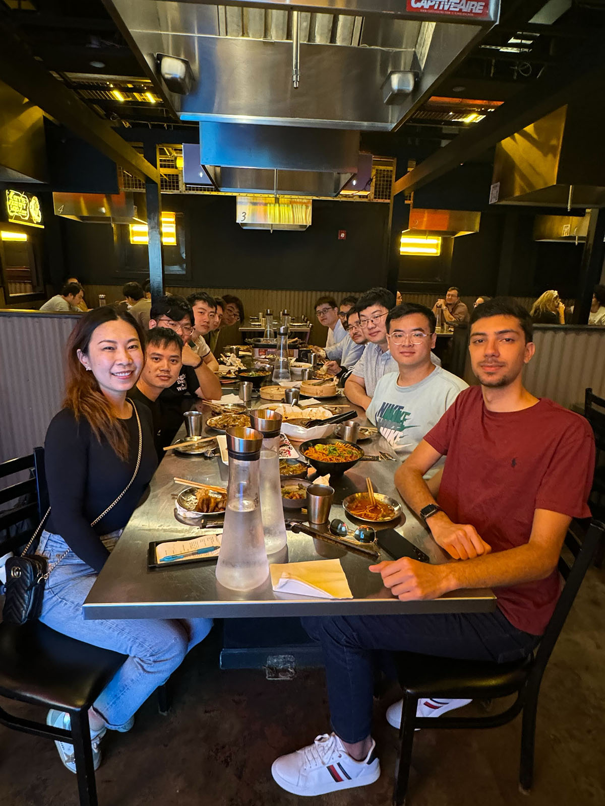 Furong Huang and members of Furong Lab seated together at dinner