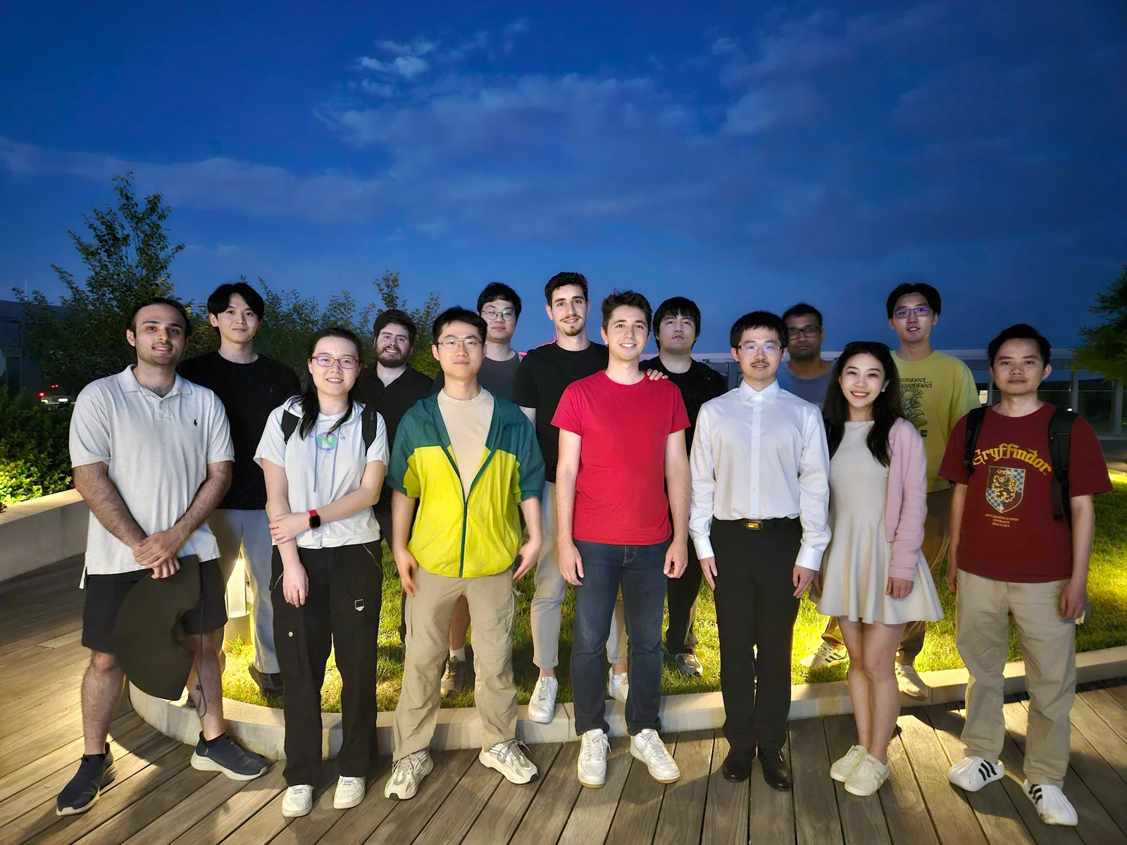 Members of Furong Lab gathered outdoors at dusk