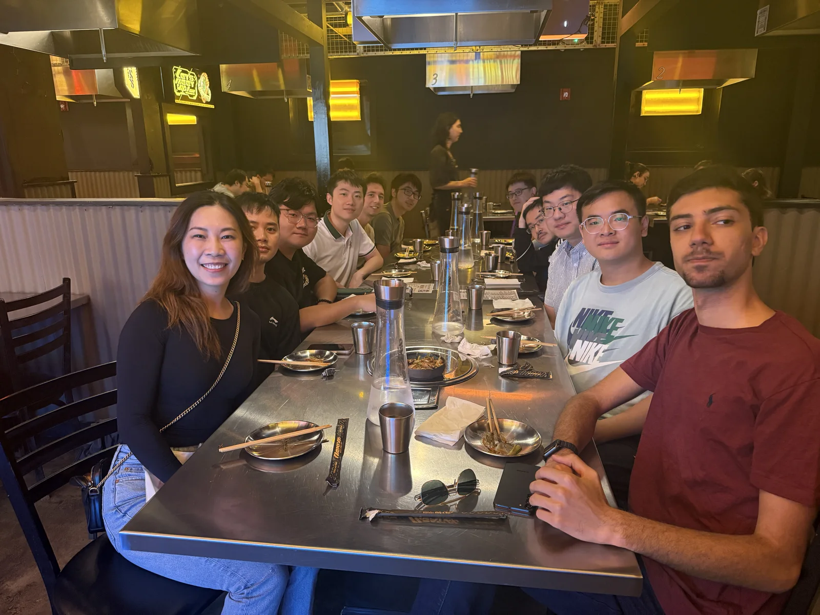 Members of Furong Lab seated together at a restaurant