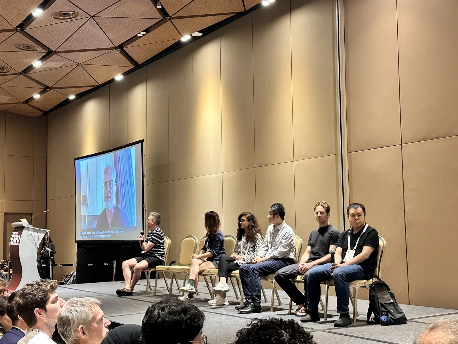 Furong Huang and fellow panelists speaking at a research event
